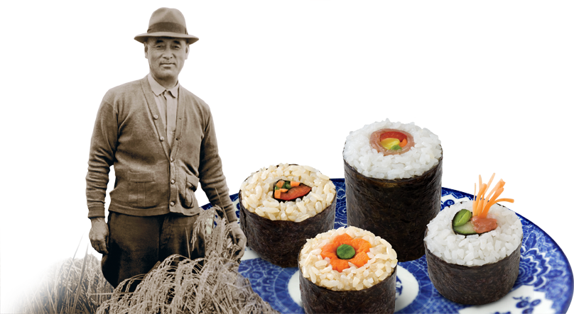 Founder, Keisaburo Koda, Circa 1930s in a rice field next to a plate of sushi. 